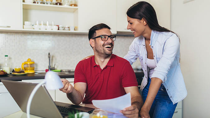 couple looking at provider update on a laptop